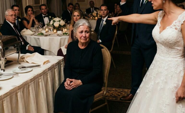 I stood frozen in the middle of my own son’s wedding when she sneered, “Don’t just stand there. Sit with the staff.” Laughter rippled through the room as she dragged a chair to the corner, treating me like a servant. My hands trembled—until a calm voice cut through the noise. “Stop this wedding. She deserves to know who this woman really is.” What happened next shattered every lie… and changed my son’s life forever.