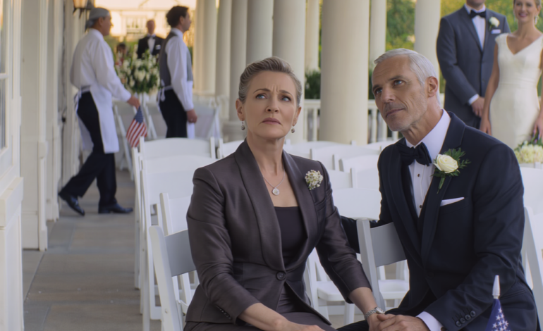 At my son’s luxury wedding, they put me in row 14 right beside the service area. The bride leaned in and whispered, ‘Please… don’t make us look bad today.’ Then a man in a black suit sat next to me and murmured, ‘Let’s pretend we came together.’ When my son looked down and saw us, his face went pale.